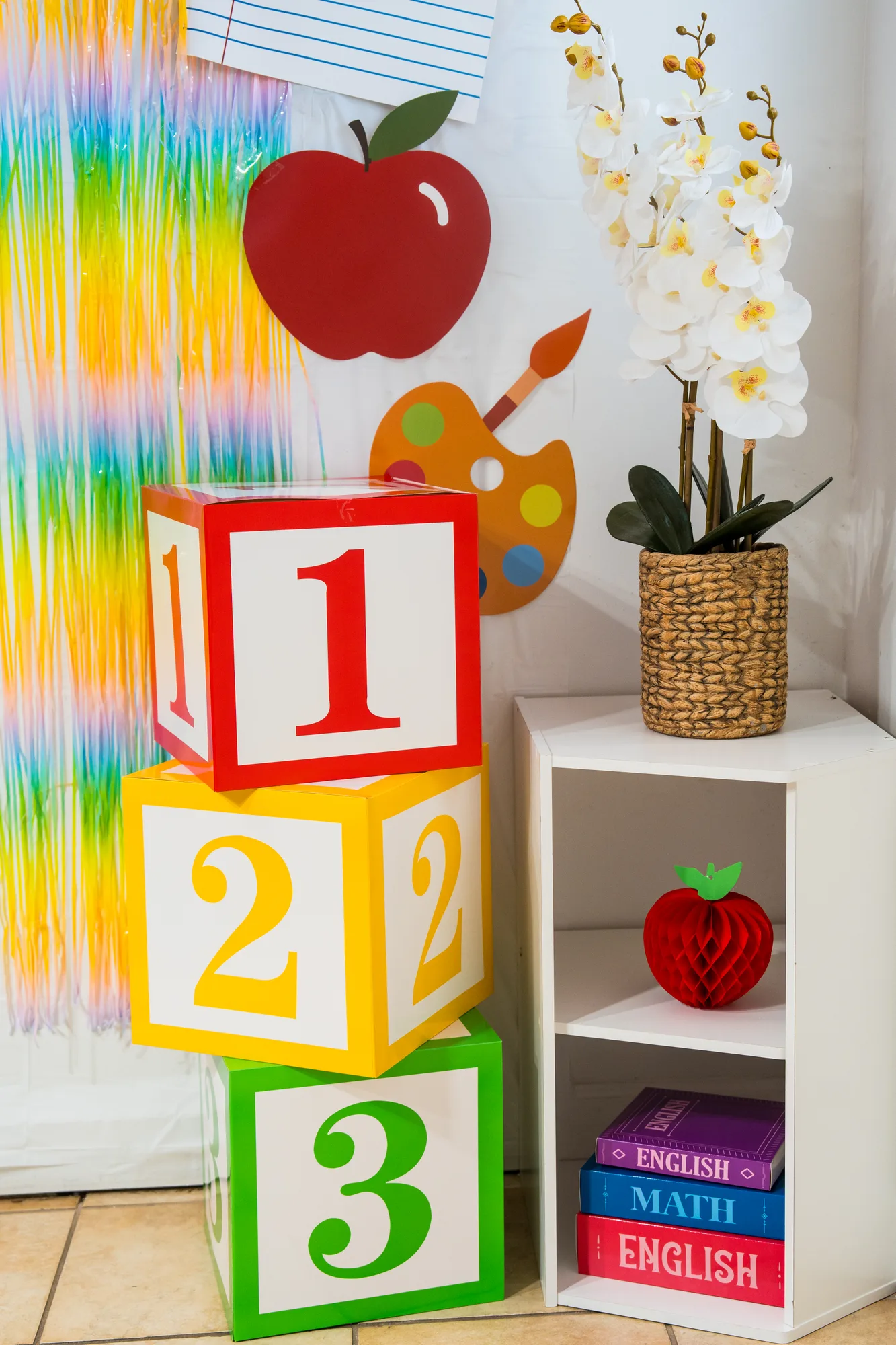 The back-to-school photo backdrop with stacked 1-2-3 blocks and an orchid
