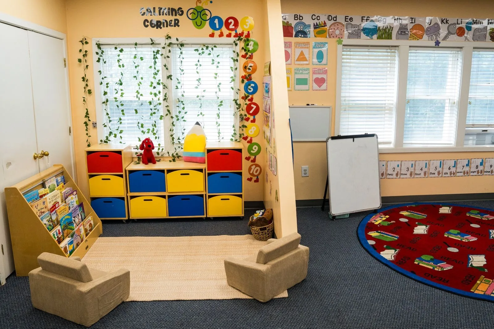 The Pre-K calming corner with armchairs, a book display, and trailing vines